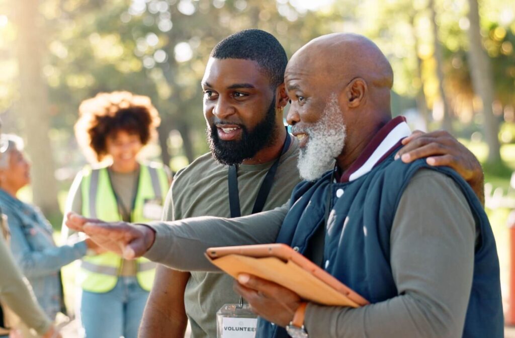 An older adult makes use of their retirement by volunteering outdoors alongside a group of passionate people